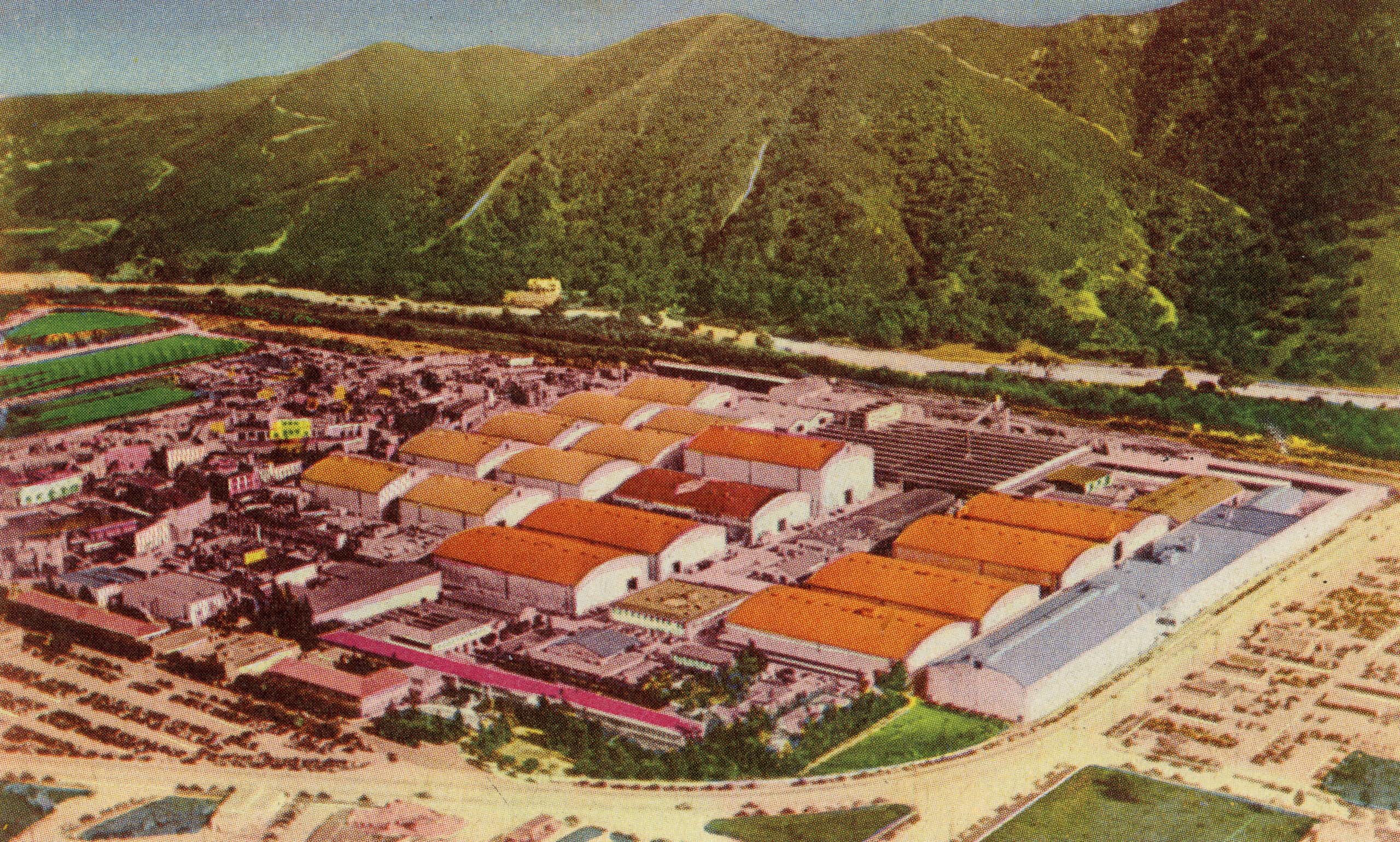 Colorful drawing of an aerial view of a sprawling movie studio, with lush hills in the background.