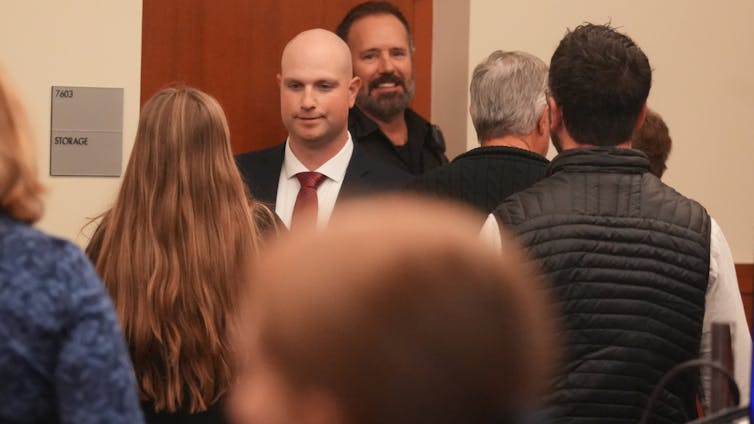 Blendon Township, Ohio, police officer Connor Grubb greets a family member after being found not guilty at a Columbus courthouse.