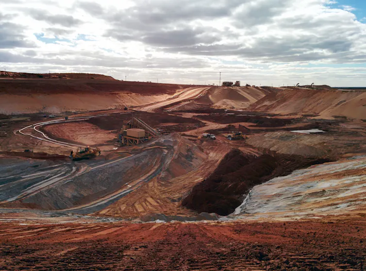 A large mine opening up red earth in outback Australia.