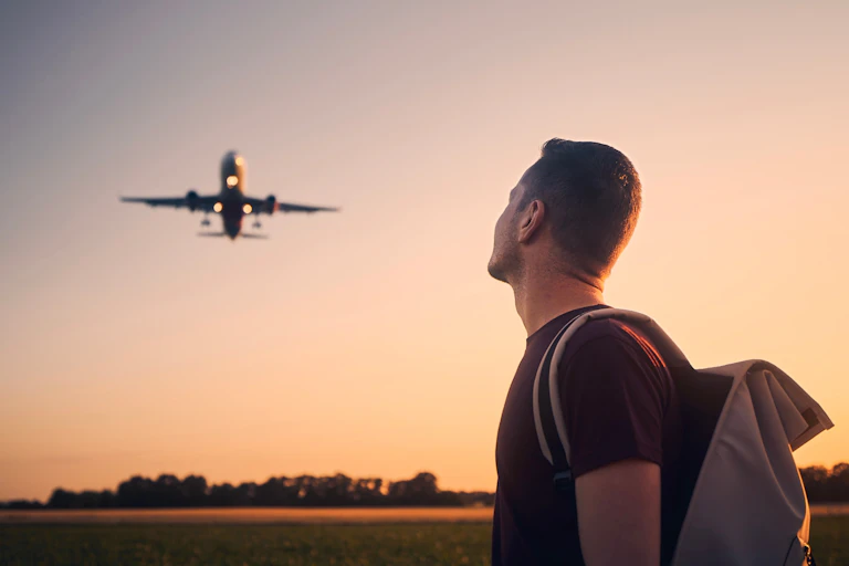 man looks up at plane