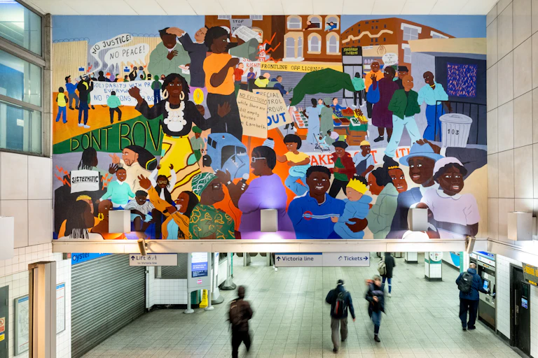 A mural showing the Afro-Caribbean community avove the entrance to Brixton tube station.