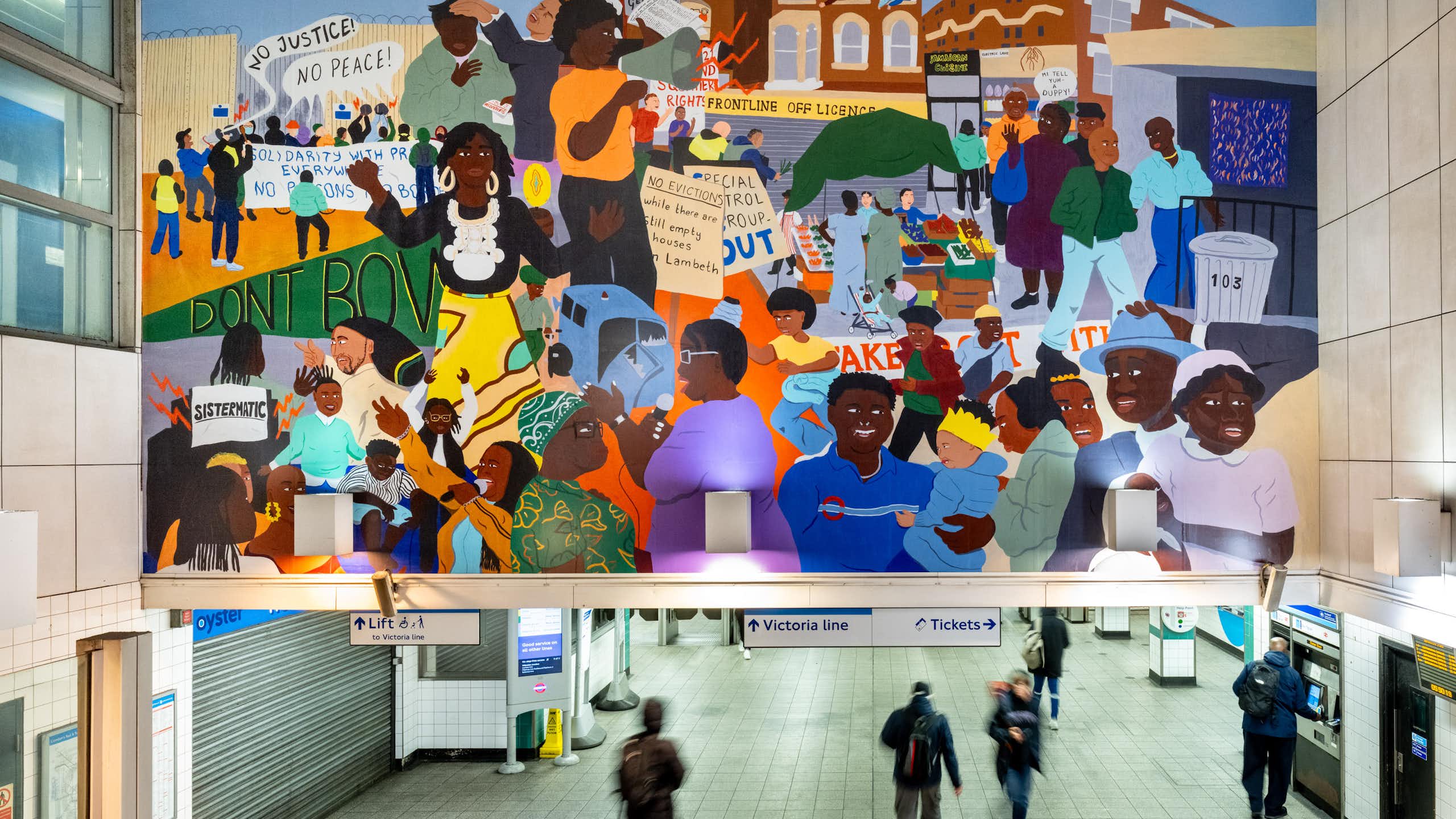 A mural showing the Afro-Caribbean community avove the entrance to Brixton tube station.