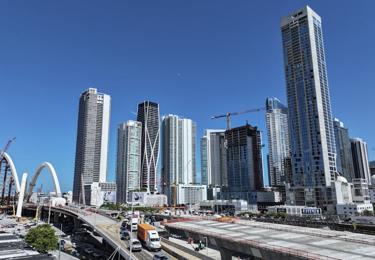 Skyscrapers in Miami, with a couple of cranes working in the background.