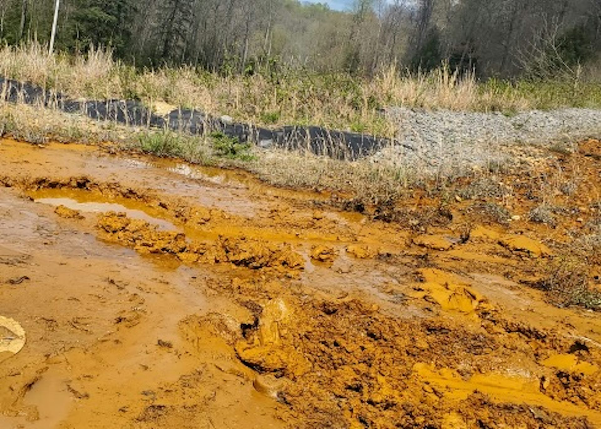 Metals flowing from acid mine waste make a creek look orange.