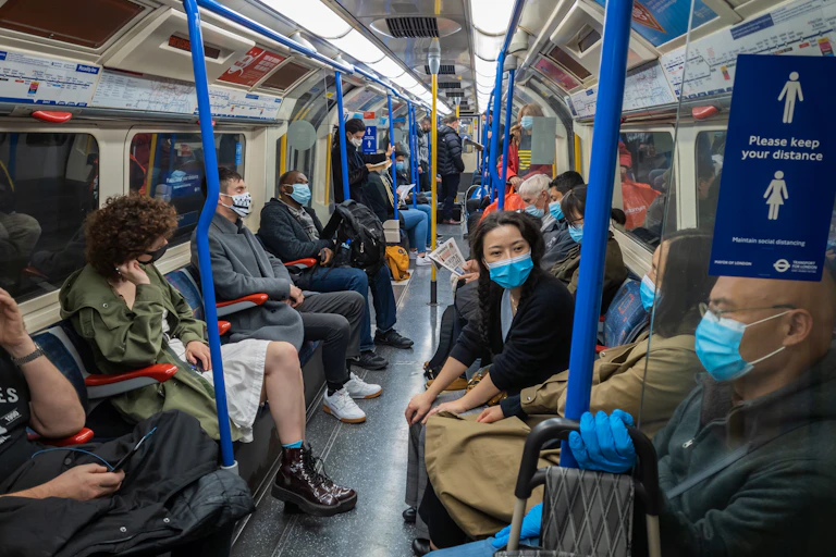 People on London Underground wearing masks during COVID.