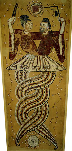 An ancient painting depicts two half-human half-snake entities, with their lower (snake) halves coiled together.