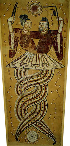 An ancient painting depicts two half-human half-snake entities, with their lower (snake) halves coiled together.