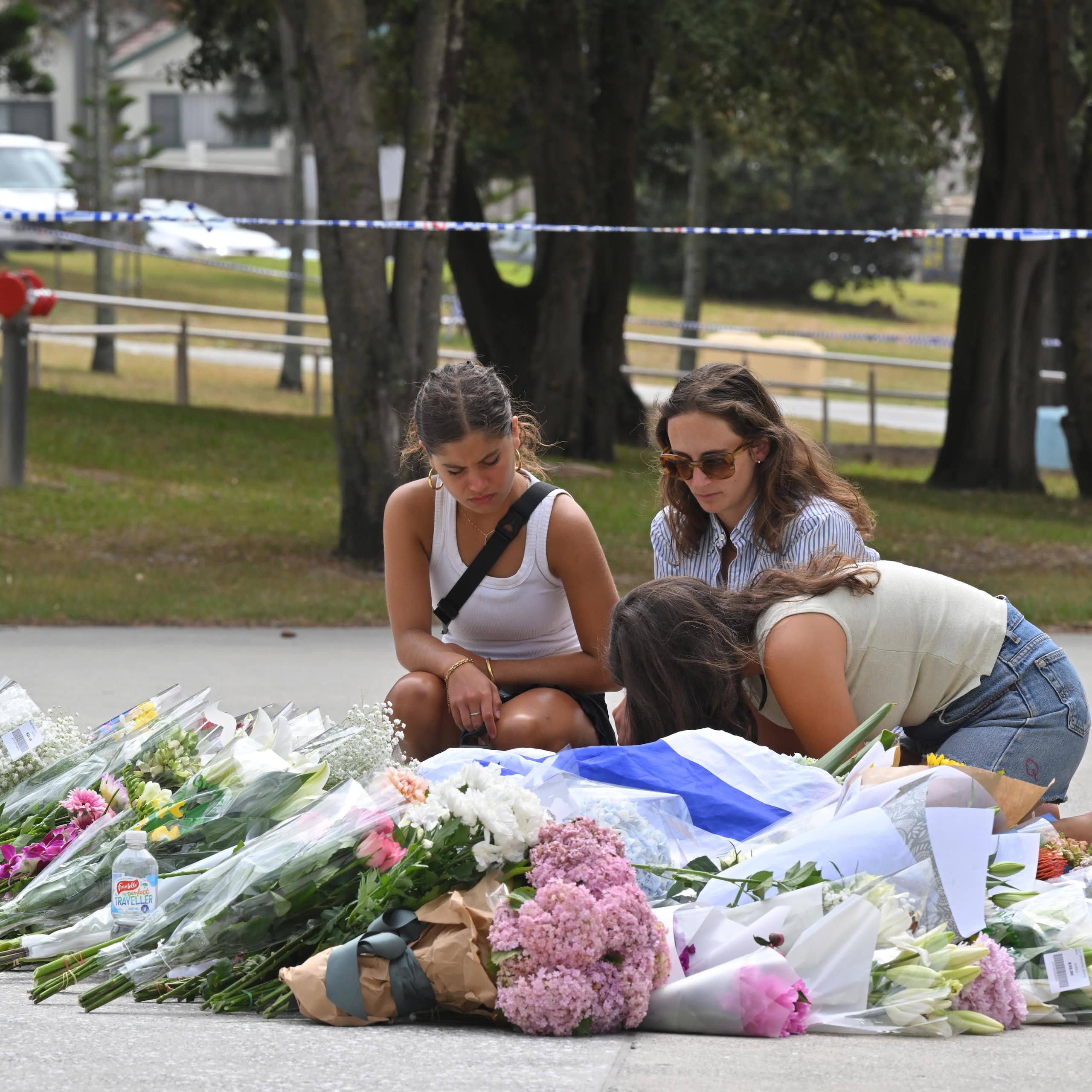 Mourners placing flowers at a makeshift memorial at Bondi Beach in Sydney, Monday, December 15, 2025