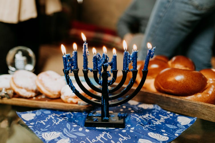 a menorah, bread and cookies on a table