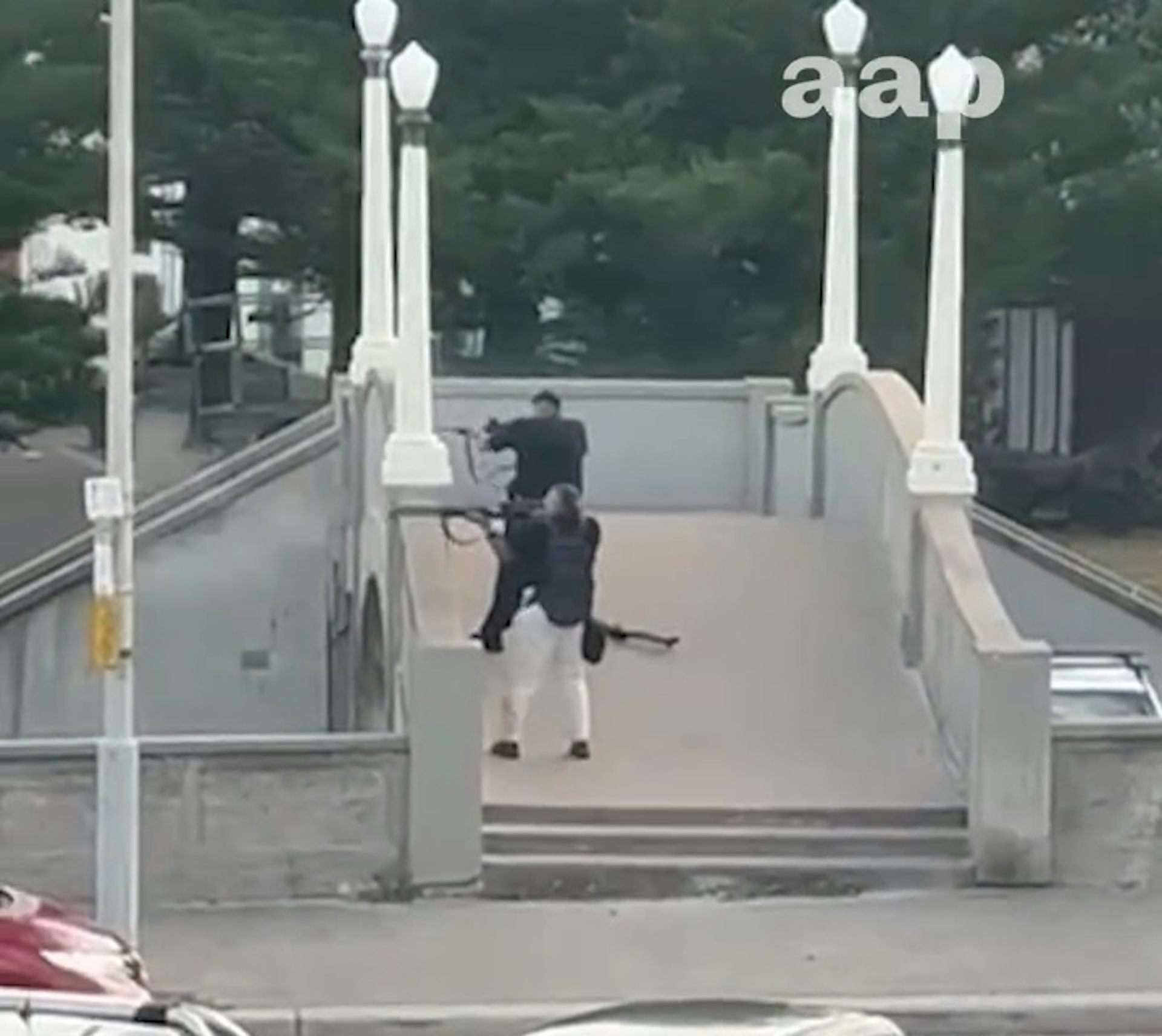 Footage shows the two gunmen beginning their attack from the bridge.