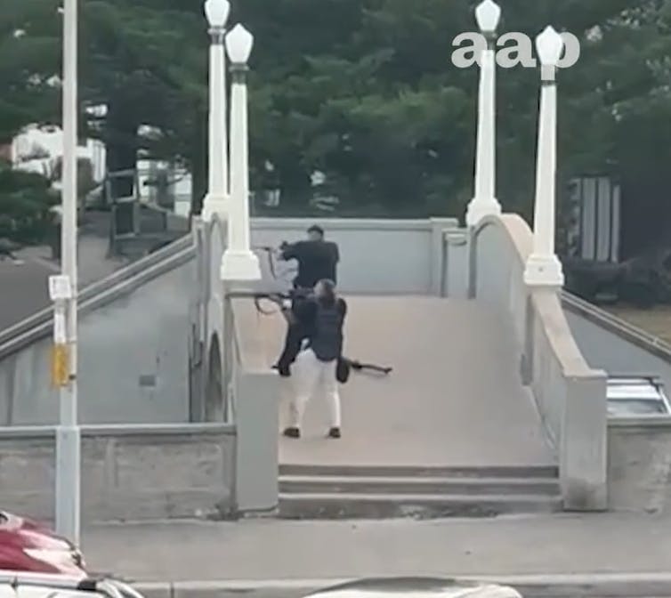 Footage shows the two gunmen beginning their attack from the bridge.