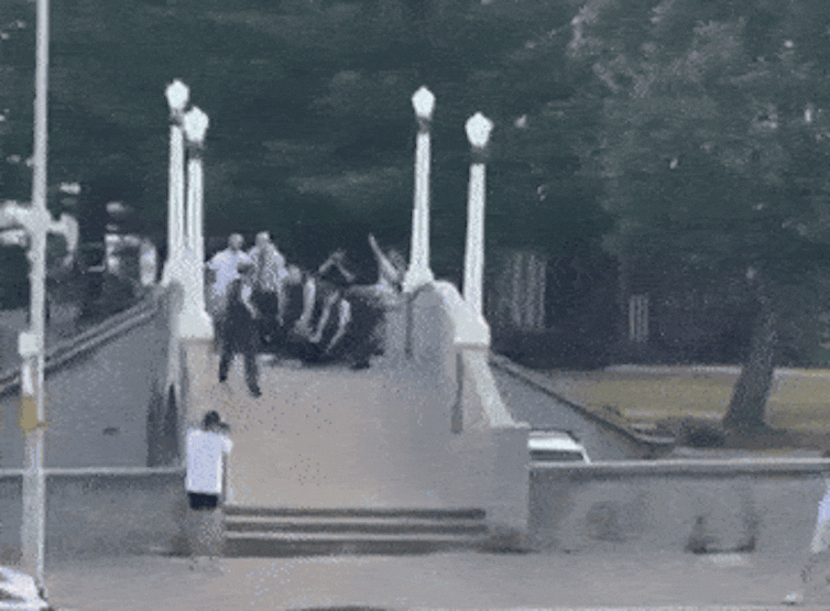 Chaos ensues as bystanders and police rush the bridge.