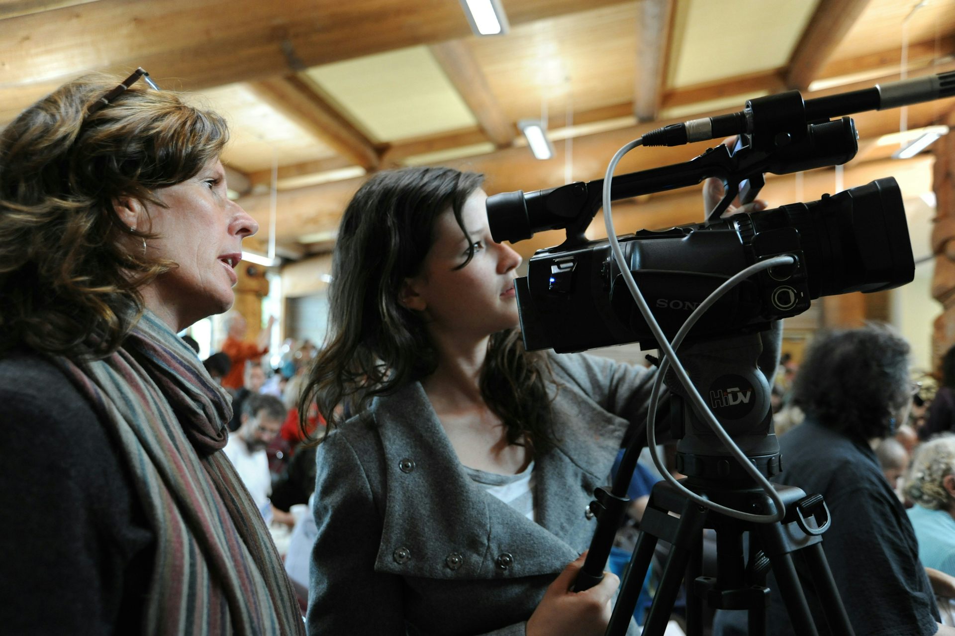Two women reports looking through a camera.