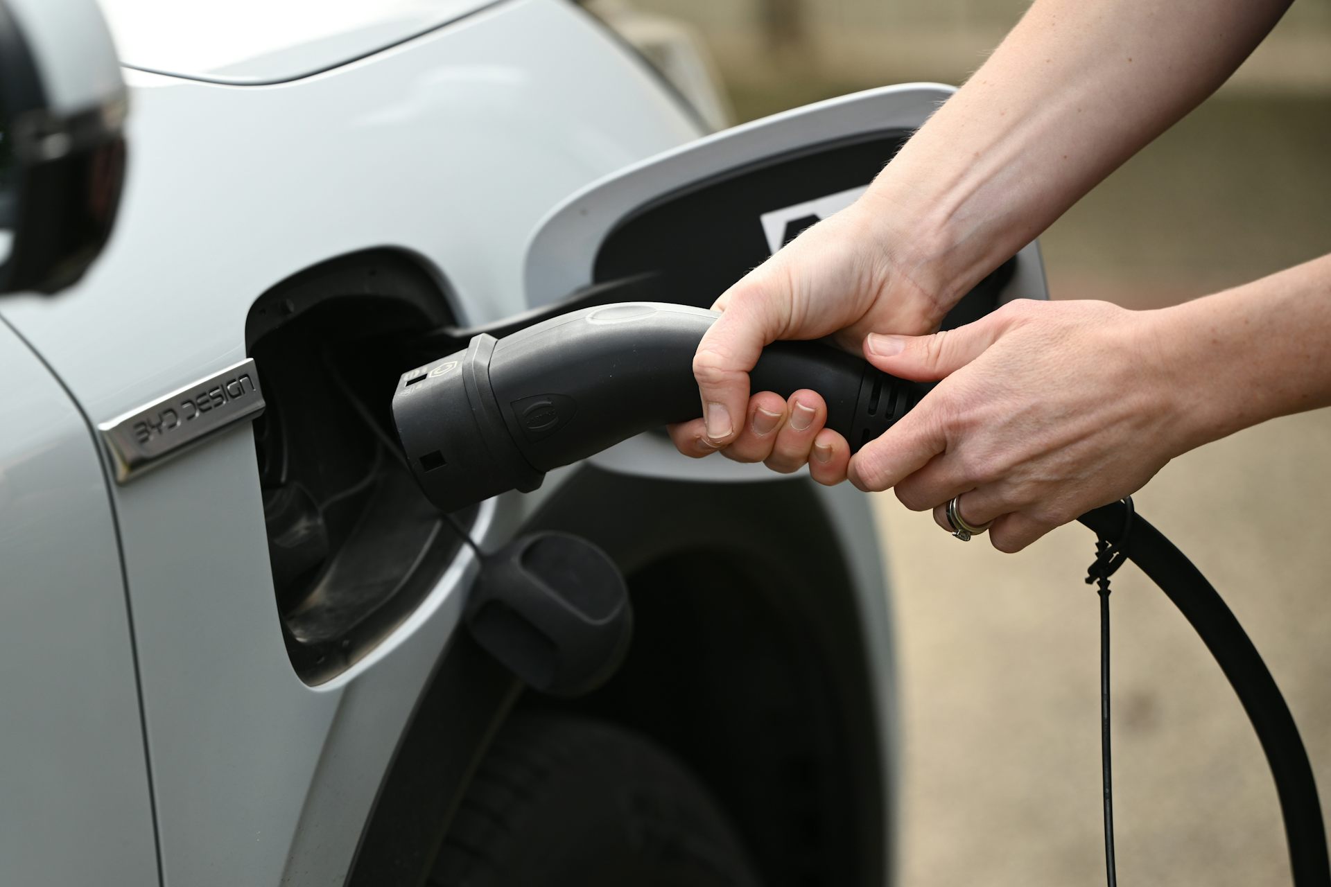 hands holding EV charger
