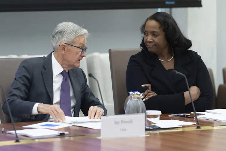 Federal Reserve Chairman Jerome Powell, left, talks with Board of Governors member Lisa Cook, right, during a Fed meeting.