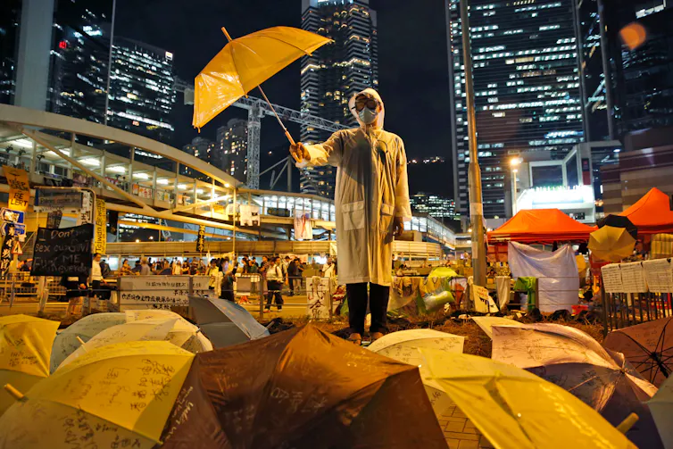 A protester holds an umbrella up during a rally on a main road in the occupied areas outside government headquarters in Hong Kong in 2014
