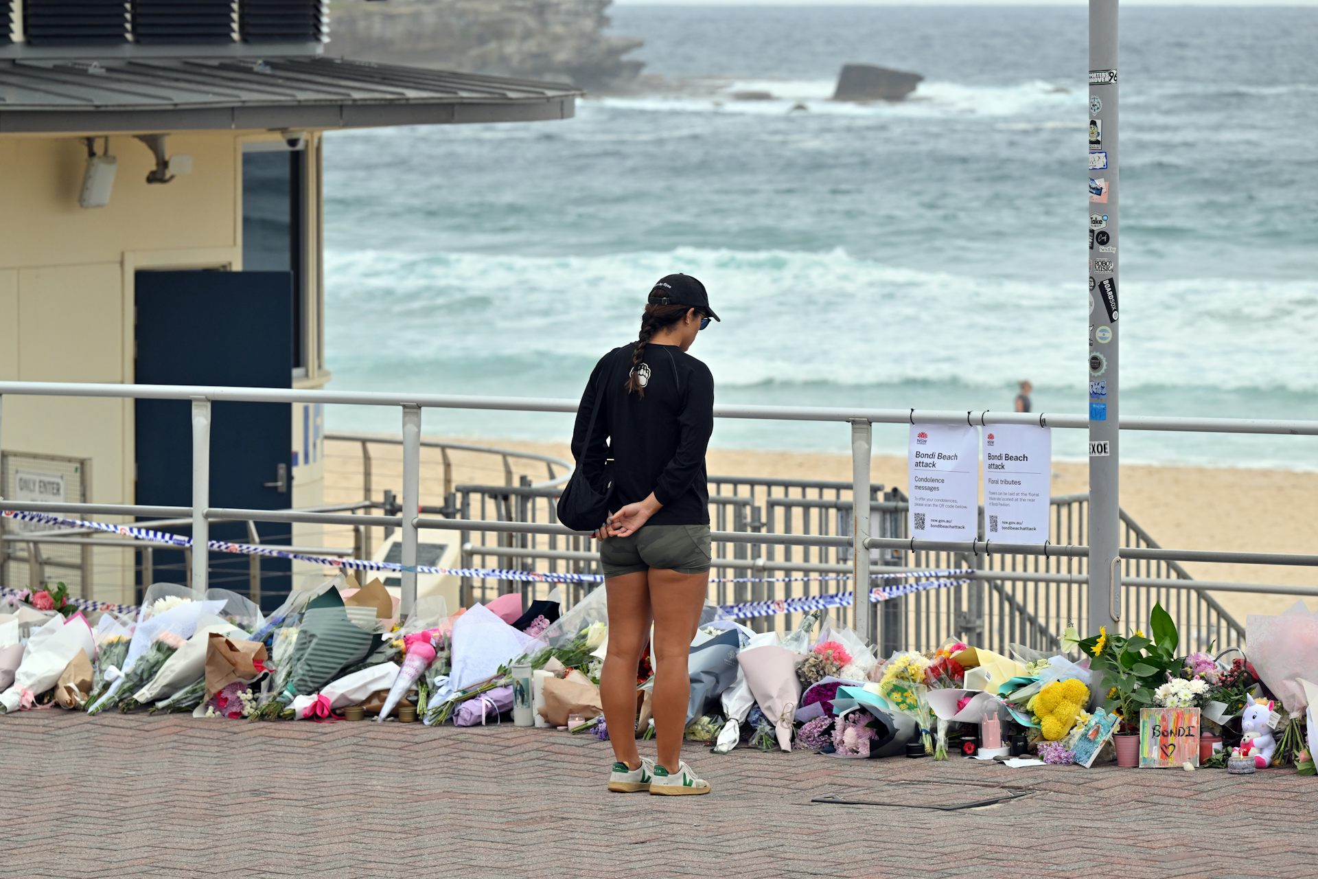 Mourners placing flowers at a makeshift memorial at Bondi Beach on Tuesday