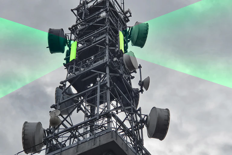 telecommunications signal tower with green beams emanating