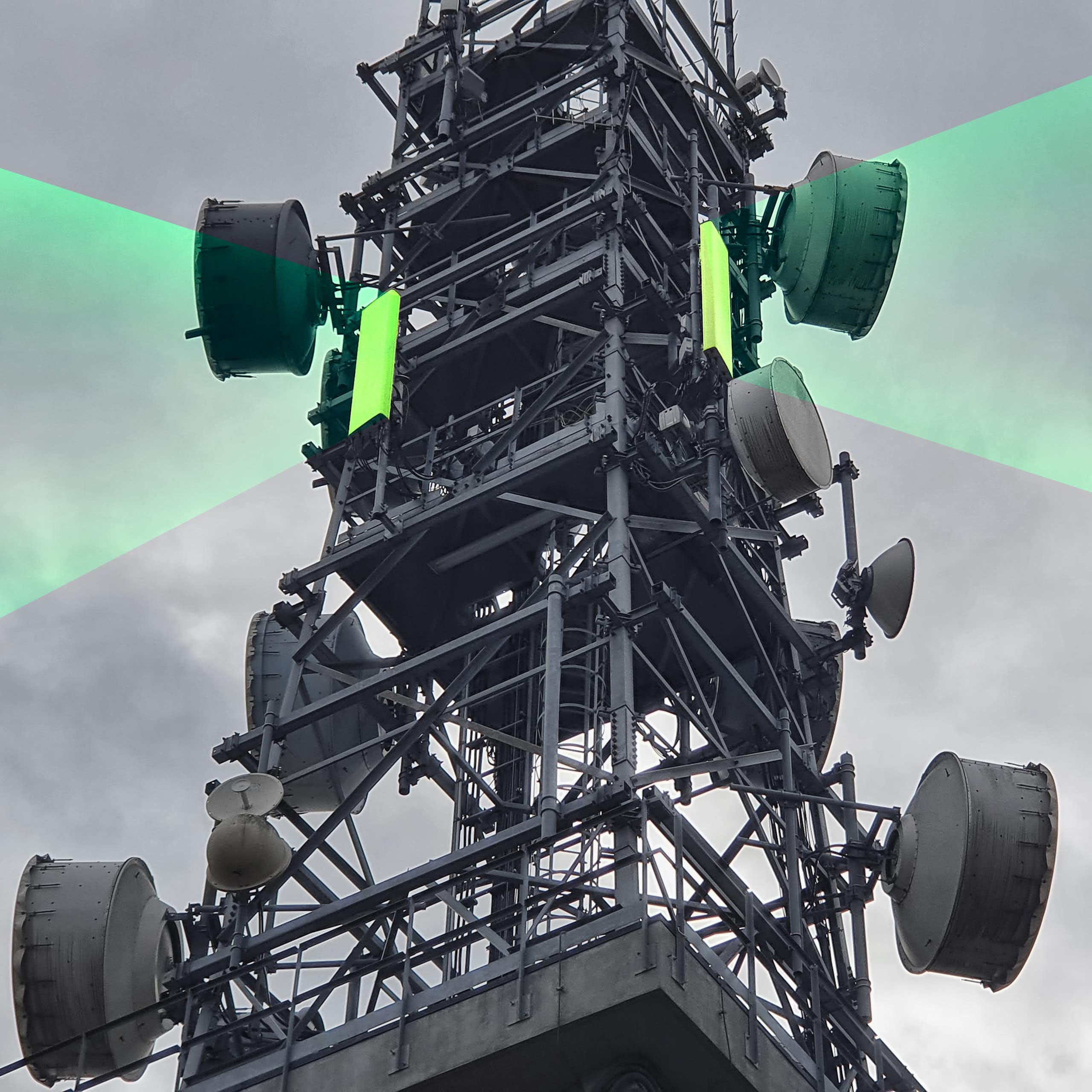 telecommunications signal tower with green beams emanating