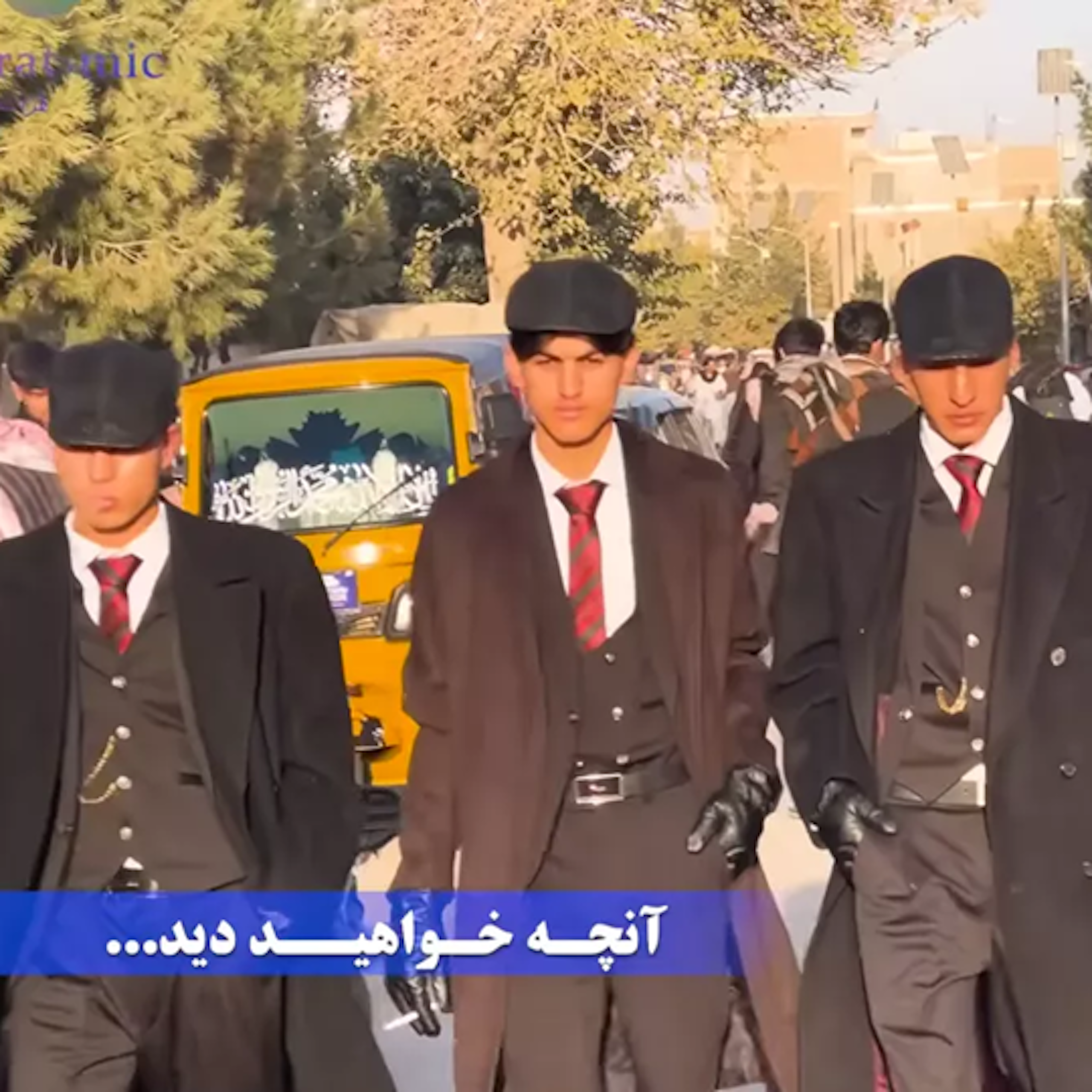 Four young Afghan men dressed as Thomas Shelby from Peaky Blinders.