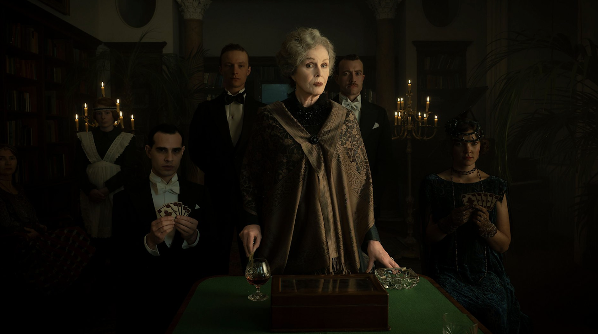 A group of severe-looking posh people in Edwardian dress.