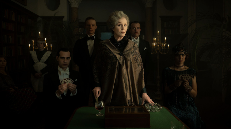 A group of severe-looking posh people in Edwardian dress.