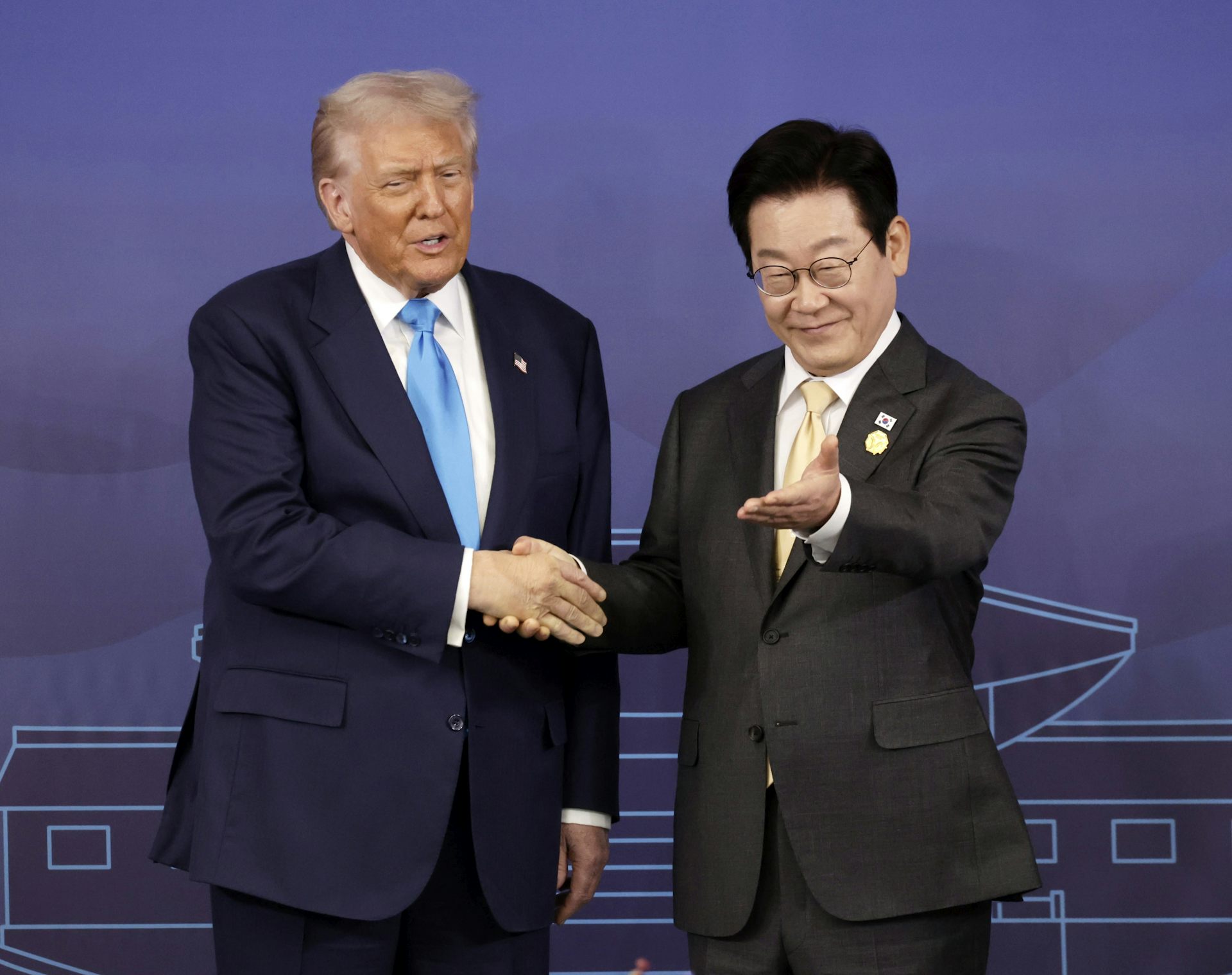 Lee Jae Myung gestures for Donald Trump to take a seat.