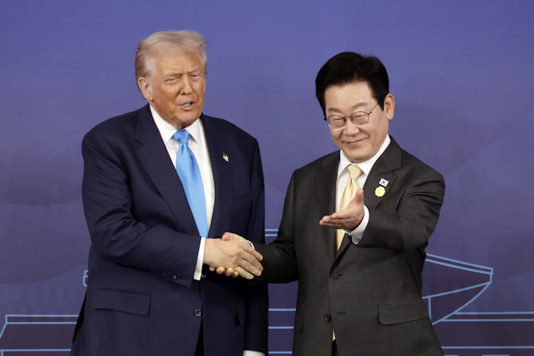 Lee Jae Myung gestures for Donald Trump to take a seat.