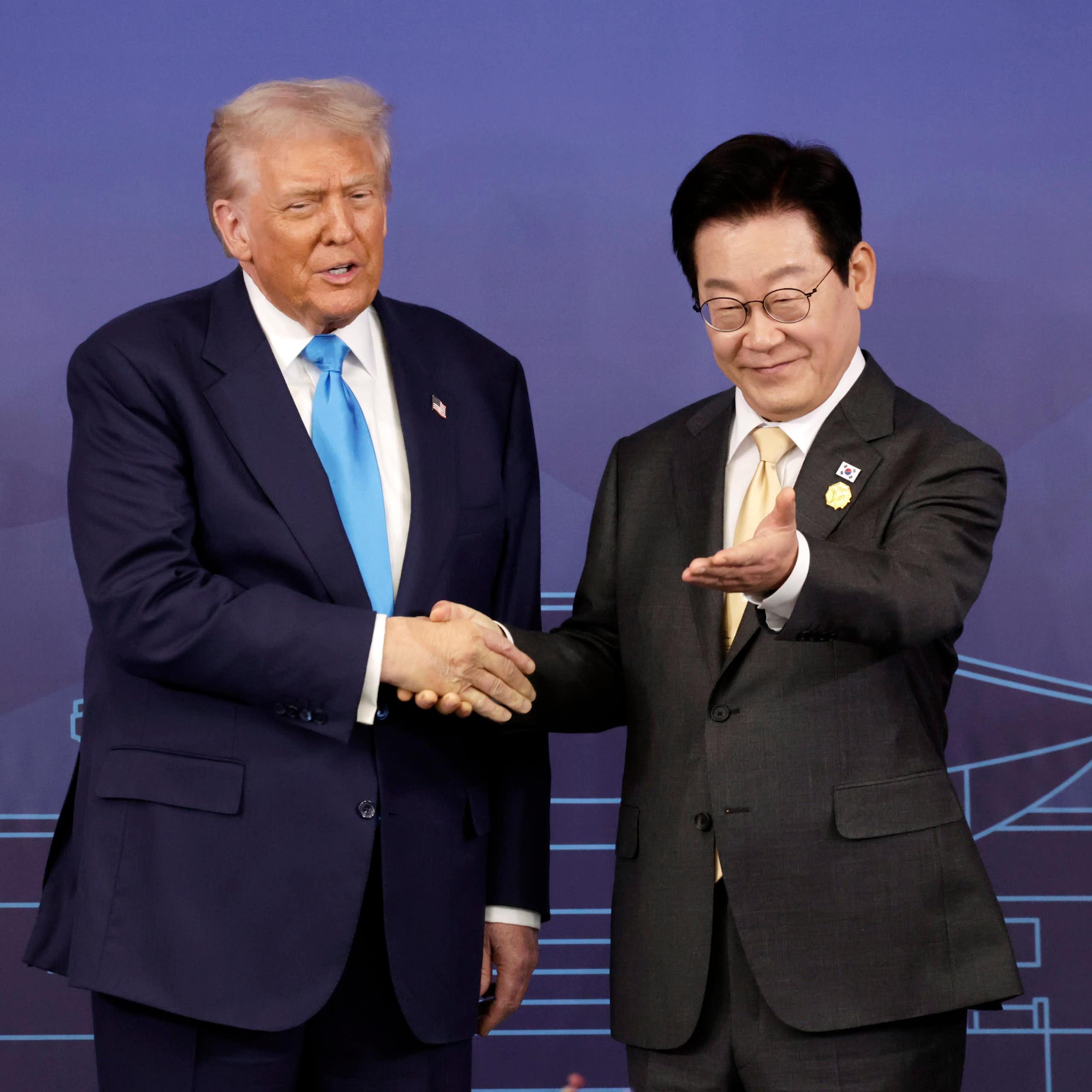 Lee Jae Myung gestures for Donald Trump to take a seat.