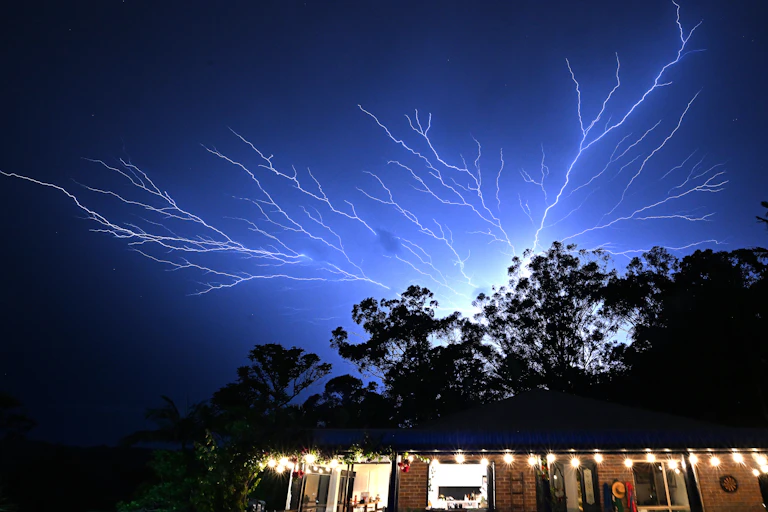 A tree-like bolt of lightning in the night sky.