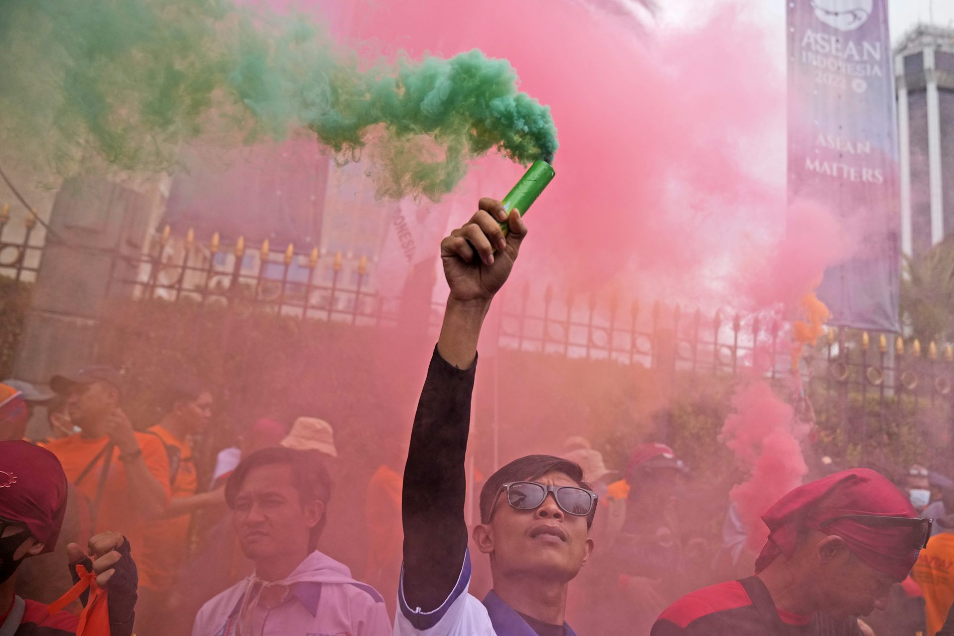 A protestor holds up a smoke stick during a May Day rally in Jakarta, Indonesia