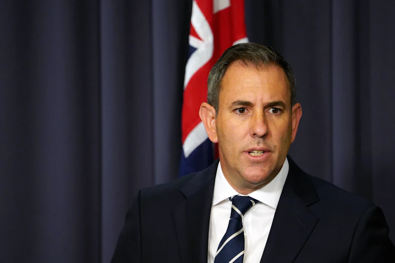 Treasurer Jim Chalmers talking at a press conference after releasing the mid-year budget update