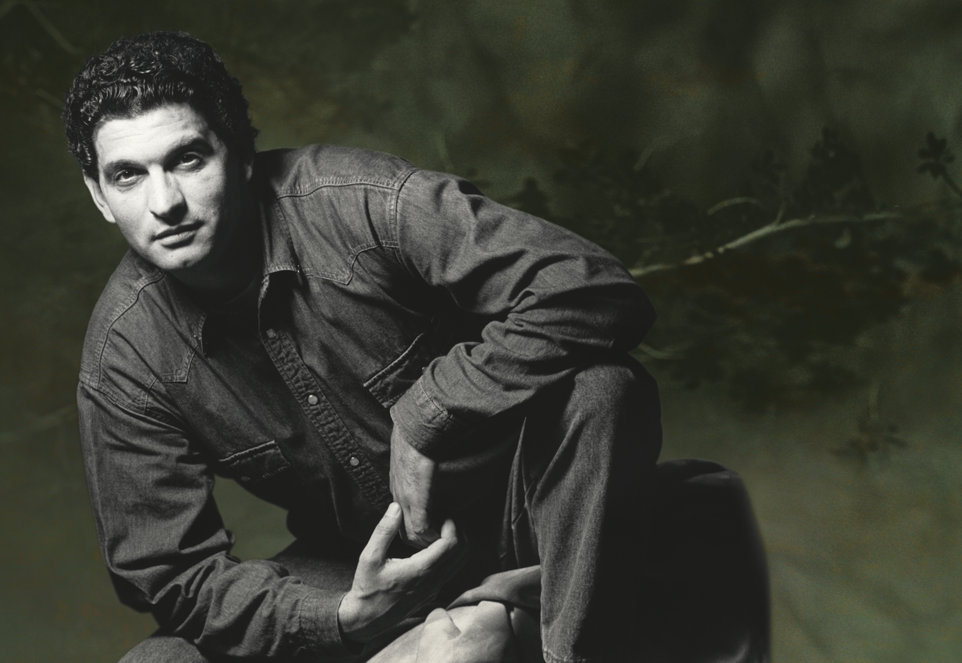 Retrato en blanco y negro de un hombre vestido con camisa vaquera.