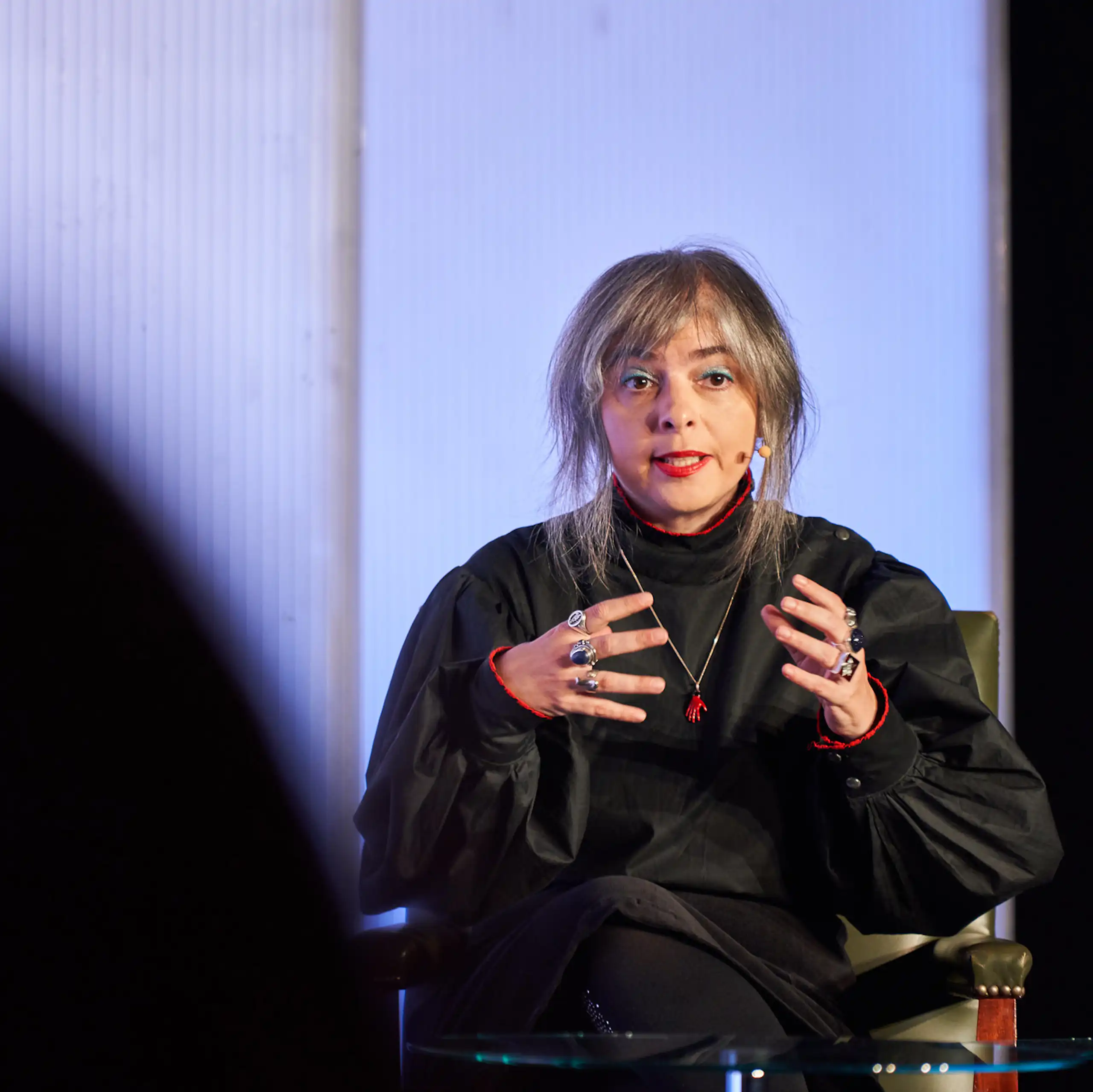 Una mujer habla con un micrófono en la oreja.