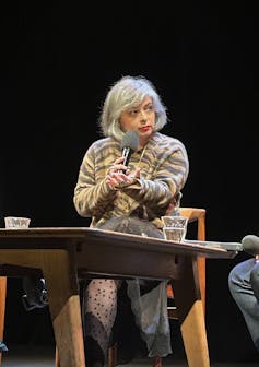 Why do we love Mariana Enriquez (teachers too) such a lot? 2 A woman with gray hair speaks into a microphone.