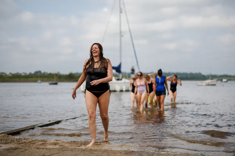 Members of the Manningtree Mermaids wild swimming group, coming out the water.