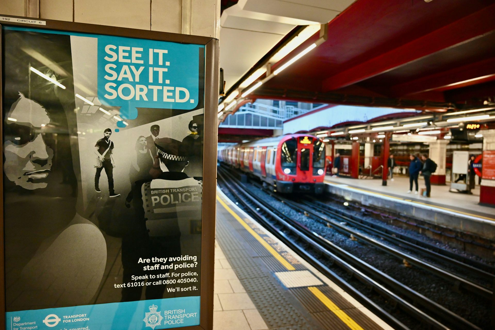 A see it, say it, sorted poster next to a track in a London tube station