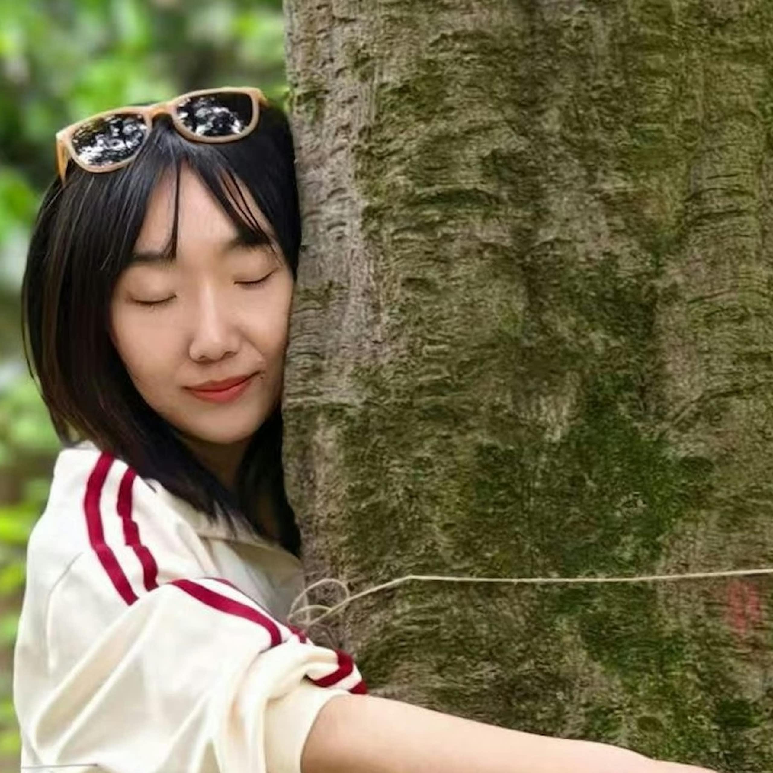 woman hugging tree