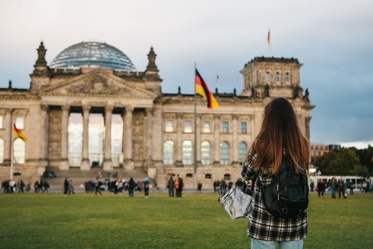 Girl looking at the Reichstag in Berlin