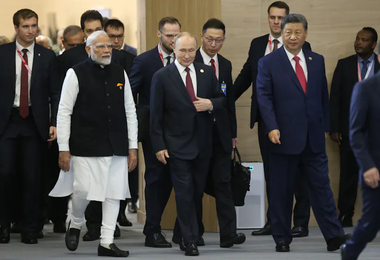A group of men walk together.