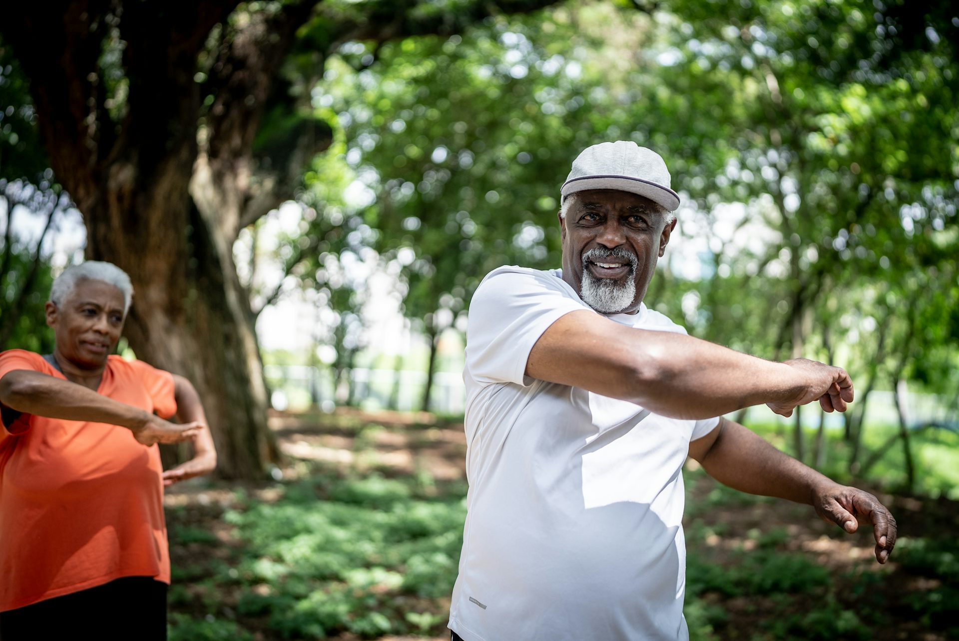 Older couple stretch in a park