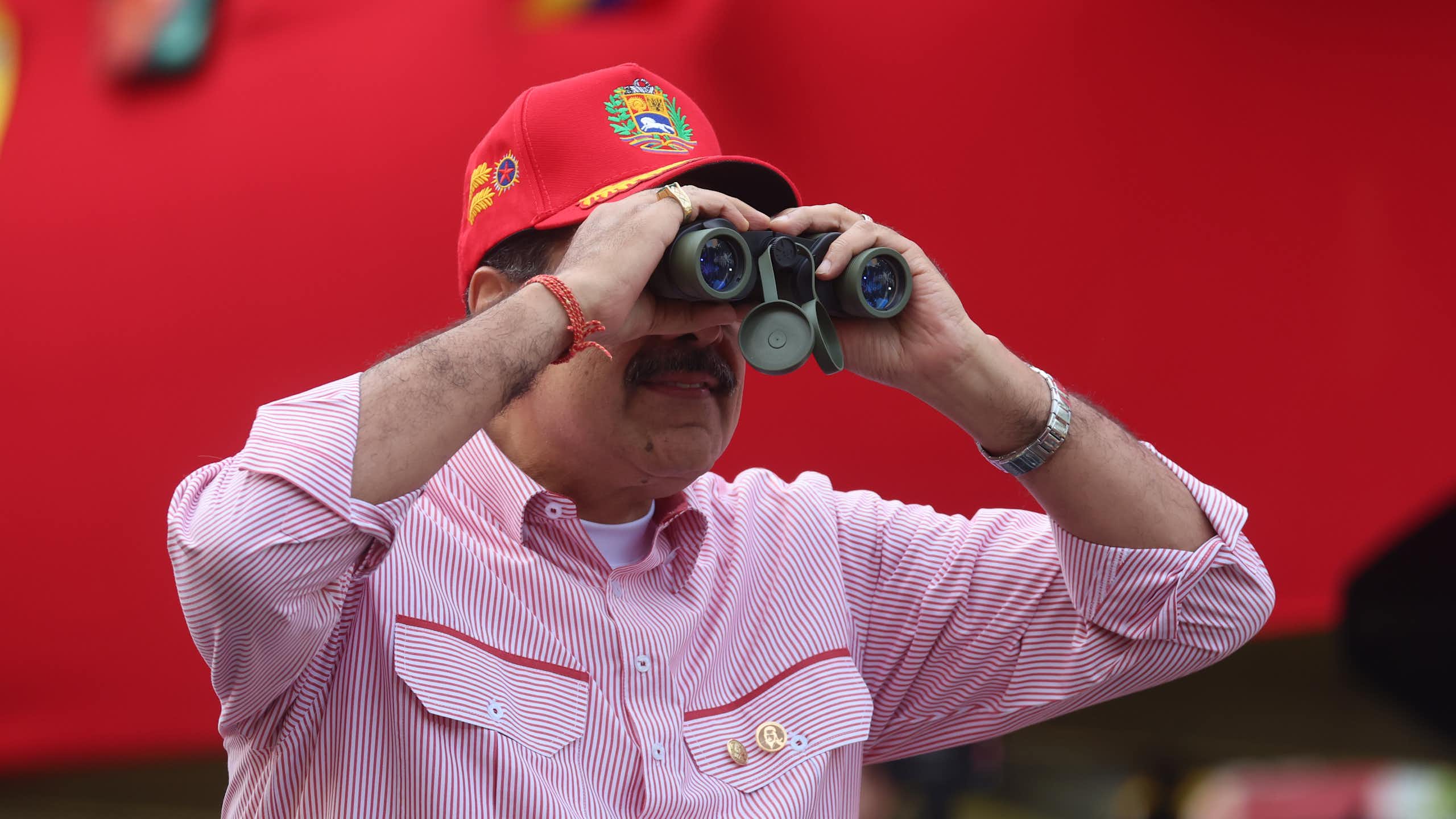 Nicolas Maduro looking through binoculars