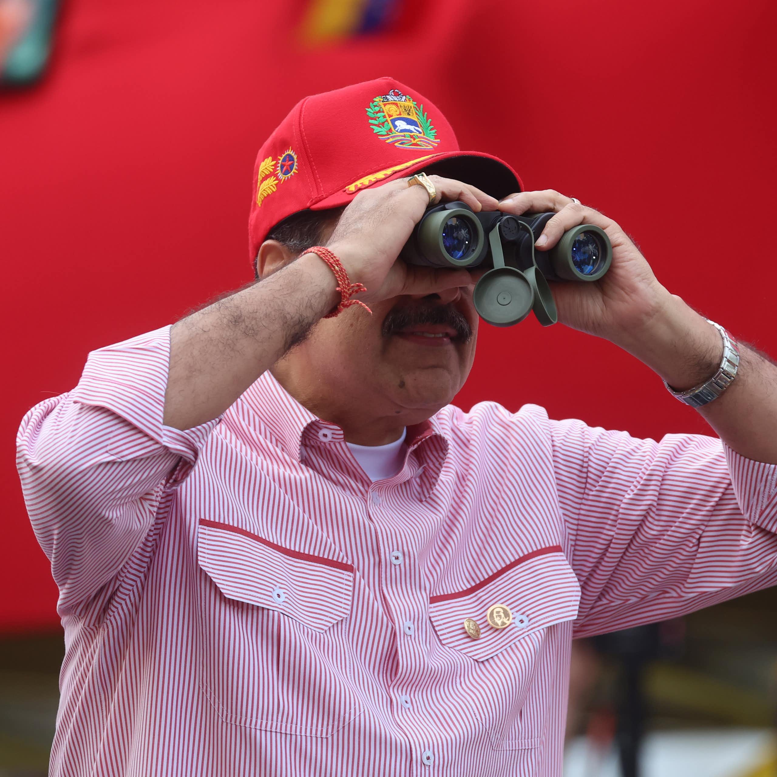 Nicolas Maduro looking through binoculars