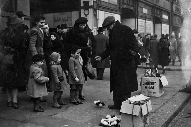 A black and white photo of a street vendor showing children mechanical toys