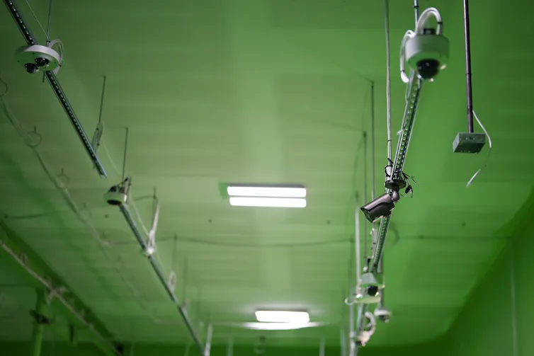 cameras mounted on a ceiling painted green