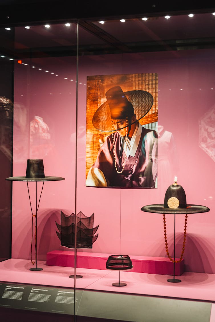 A collection of hats in a display case.