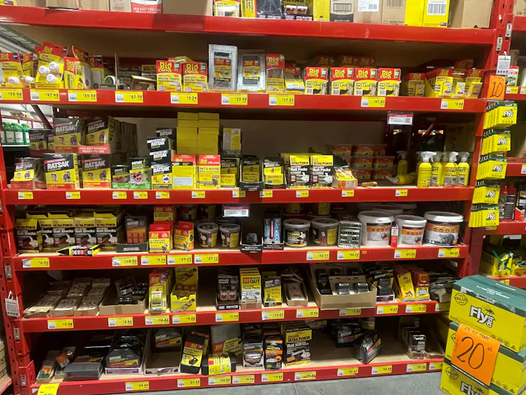 A shelf full of various industrial products, including rodent poisons.