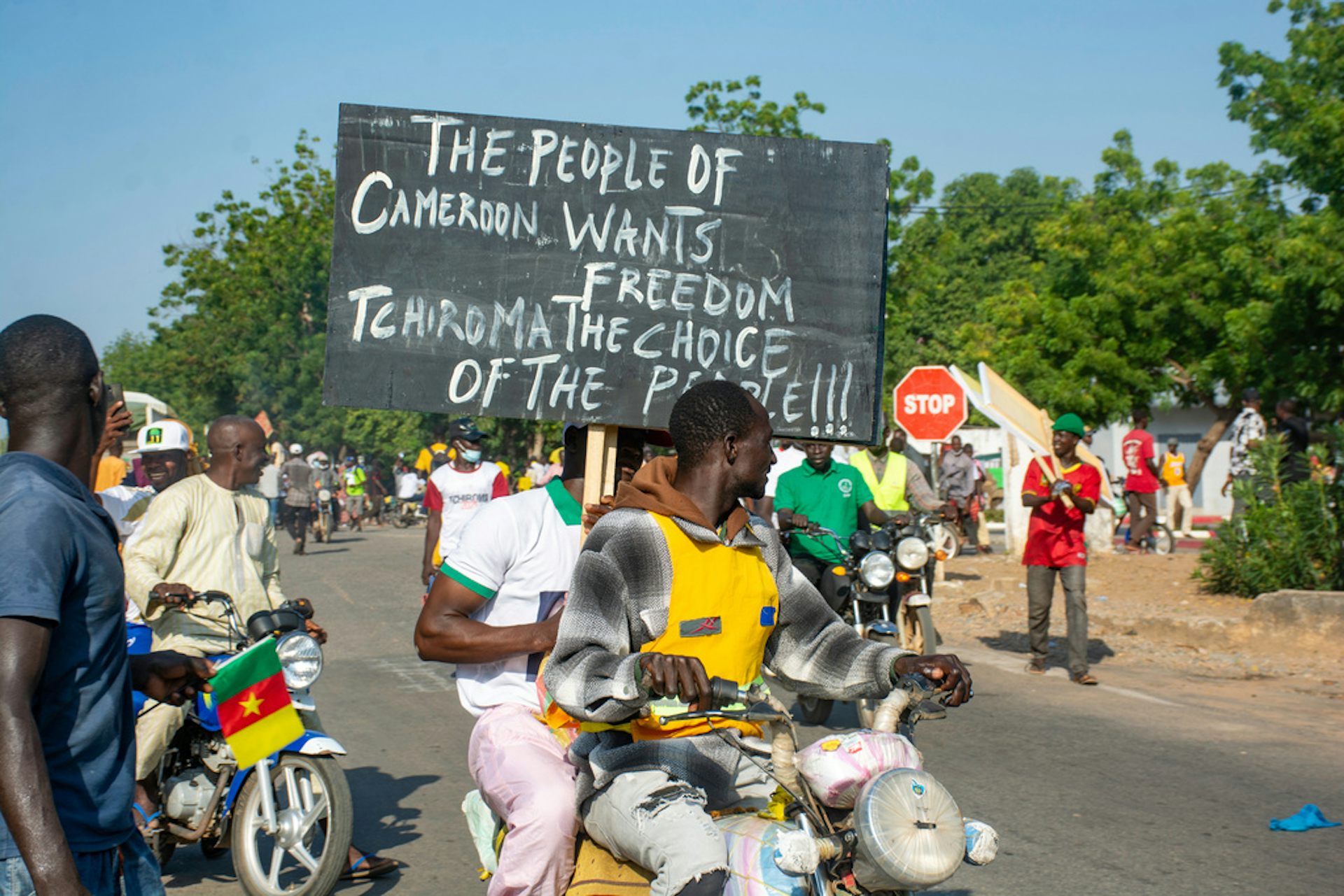People demonstrates on the street with signs.