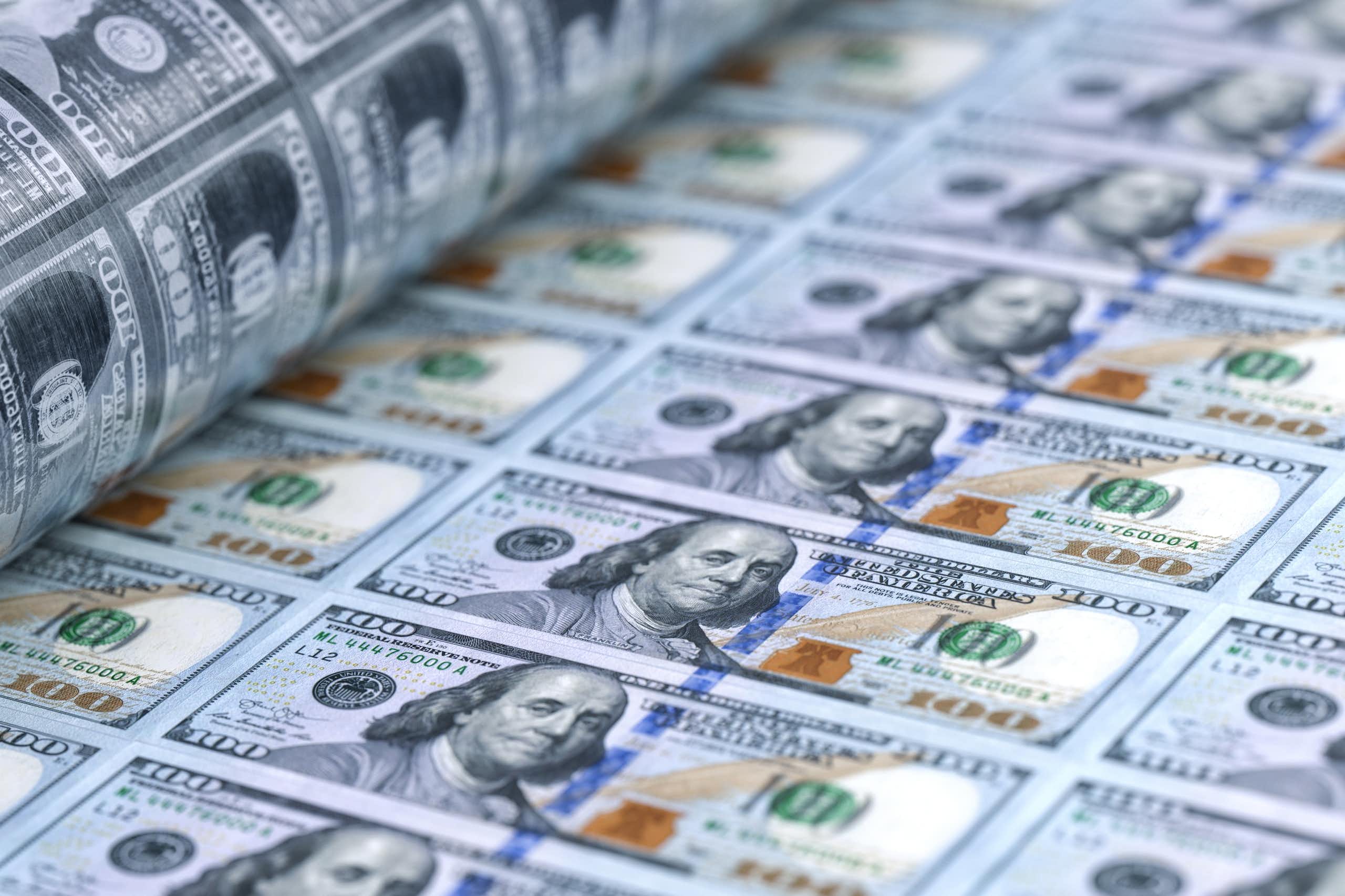 A sheet of 100 dollar bills being printed.