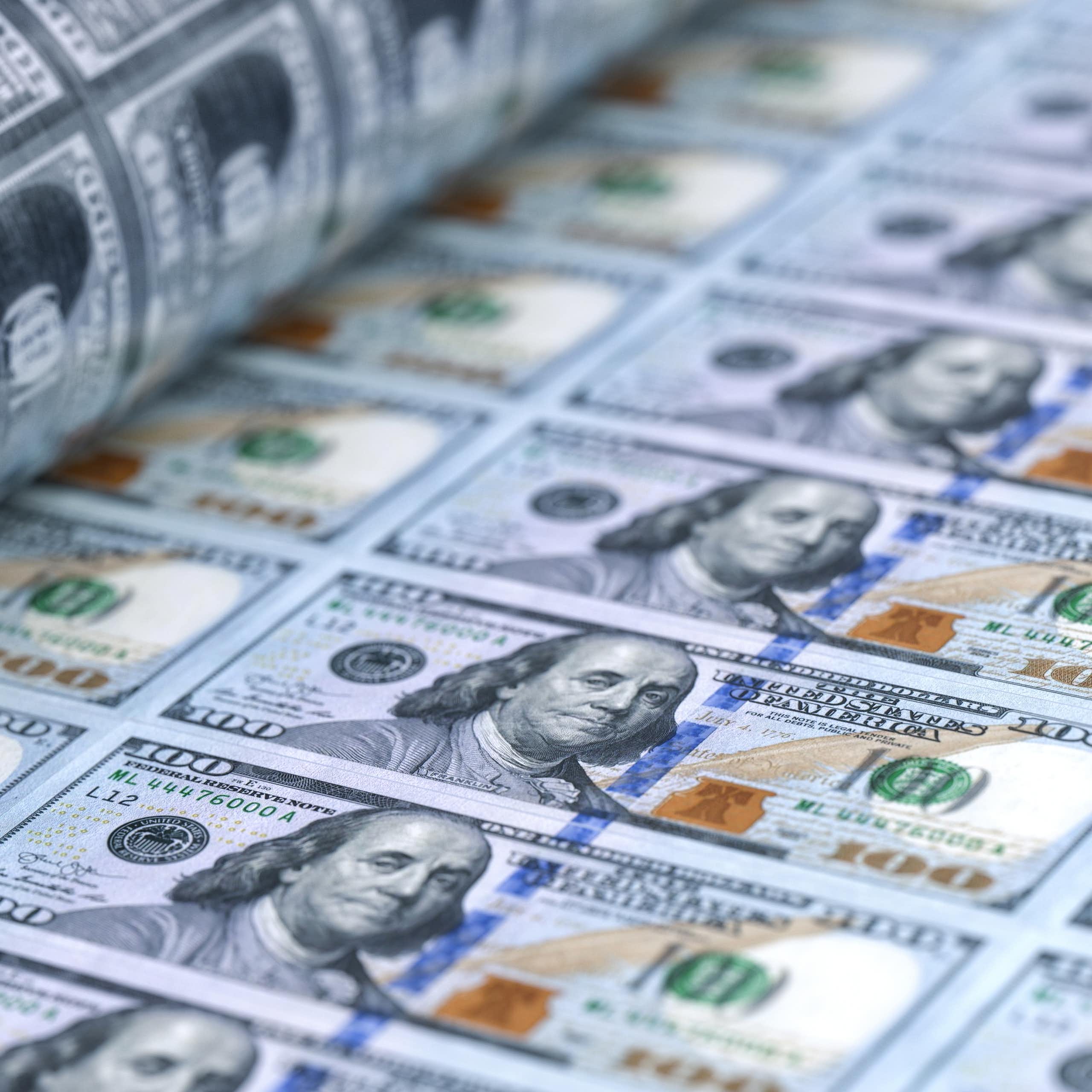 A sheet of 100 dollar bills being printed.